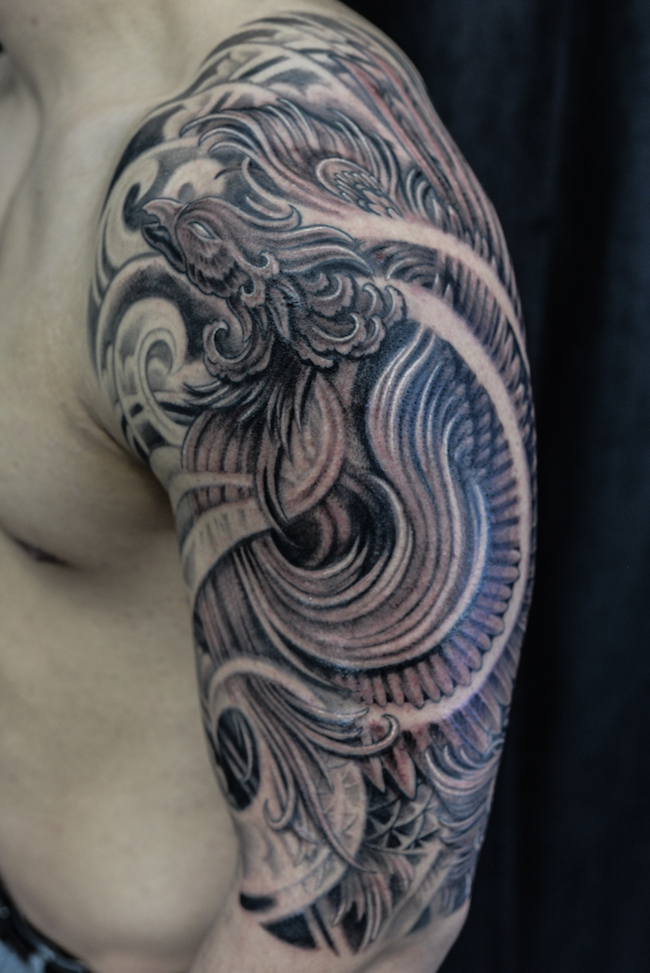 Half sleeve black and grey Phoenix tattoo.